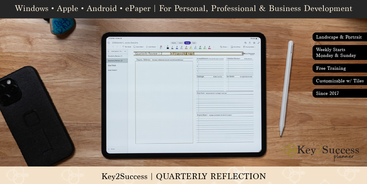 Digital planner interface featuring Key2Success Quarterly Review page, with blank sections for reflection and progress tracking, alongside a stylus and smartphone on a wooden surface.