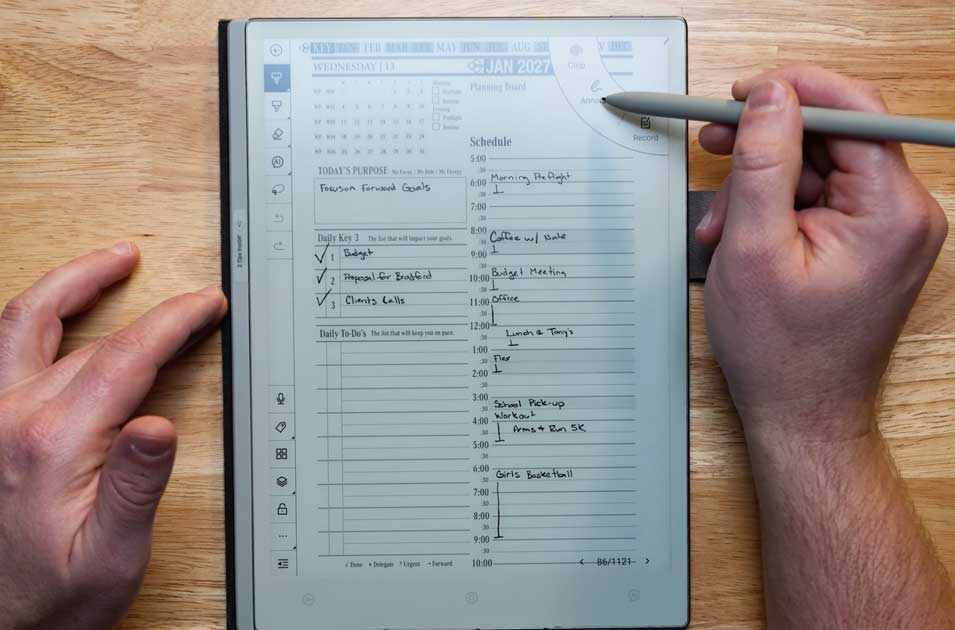 Hand holding an E-Ink tablet displaying a digital planner layout with a daily schedule, to-do list, and checkboxes, illustrating productivity features relevant to Viwoods and digital planning tools.