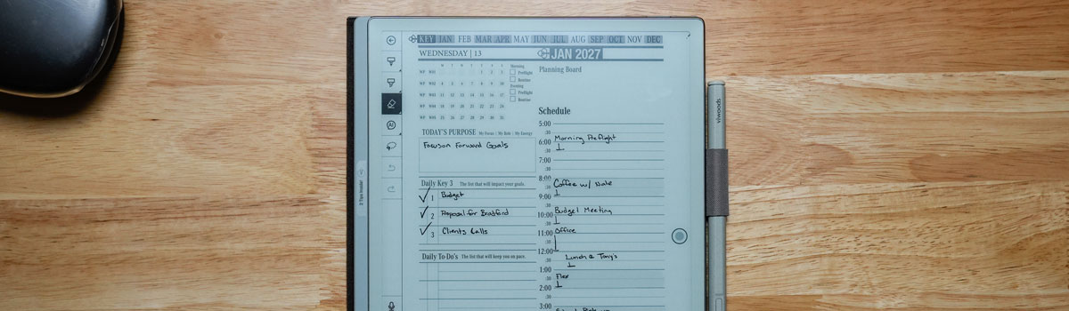 Viwoods eInk Digital Planner displaying a daily schedule and goals for January 2027, highlighting planning features and interactive layout on a wooden surface with a stylus.